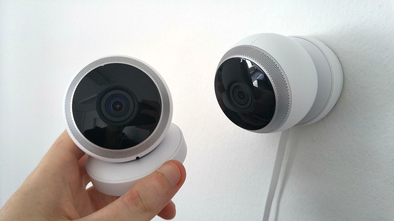 Videocamera di sorveglianza smart installata in un ambiente domestico, con segnali di avviso.